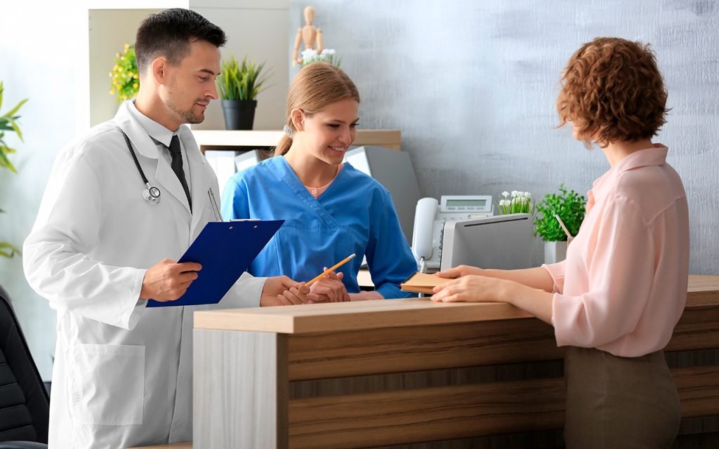 Friendly nurses assisting a patient in an office