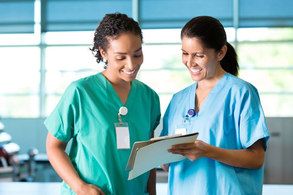 Nurses working together while reviewing medical chart